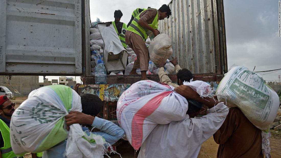 Volunteers load relief food bags on a truck in Karachi, Pakistan, on August 28.