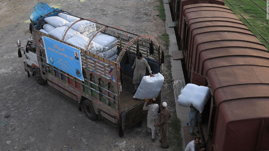 Workers load sacks of relief goods for flood victims in Balochistan, Pakistan, on August 5.