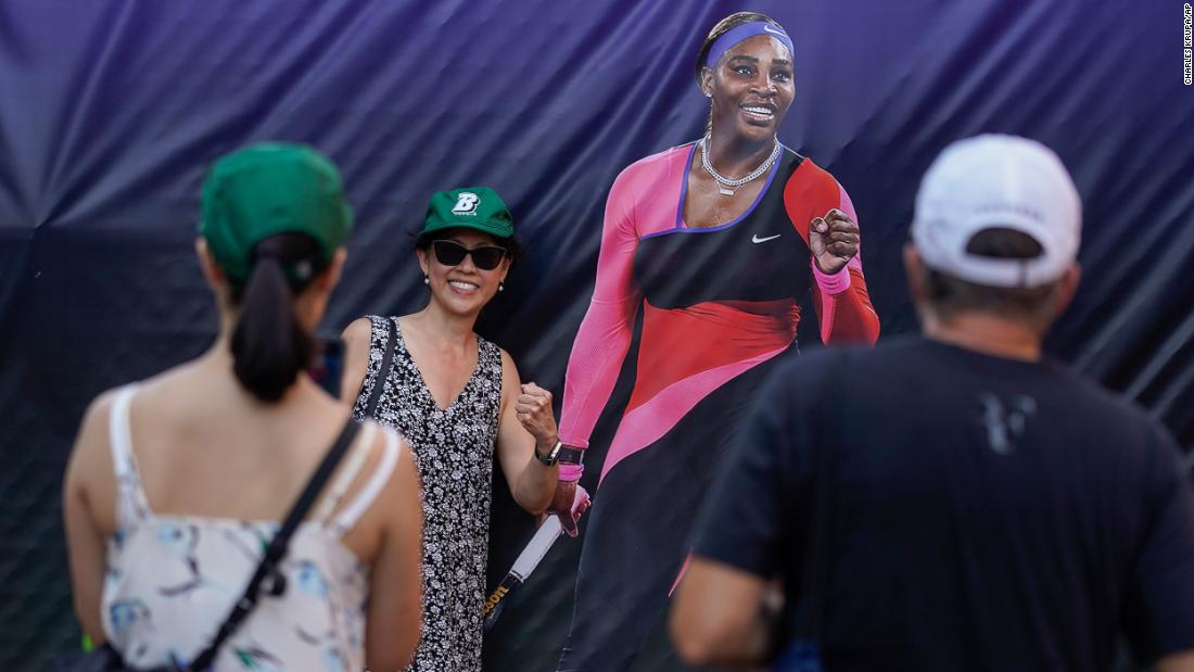 Fans pose for photos next to a life-sized image of Williams on Monday.