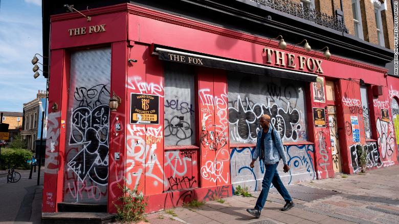Graffiti covers a closed-down pub in London.