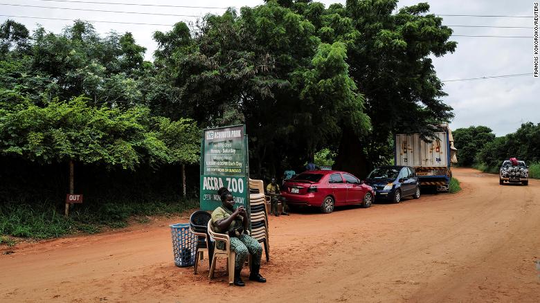 A warden guards the entrance of Accra Zoo on Monday following the lion attack.