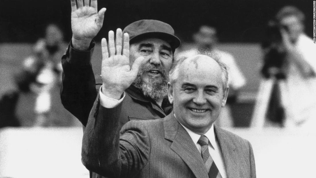 Gorbachev and Cuban President Fidel Castro wave during Gorbachev's visit to Cuba in April 1989.