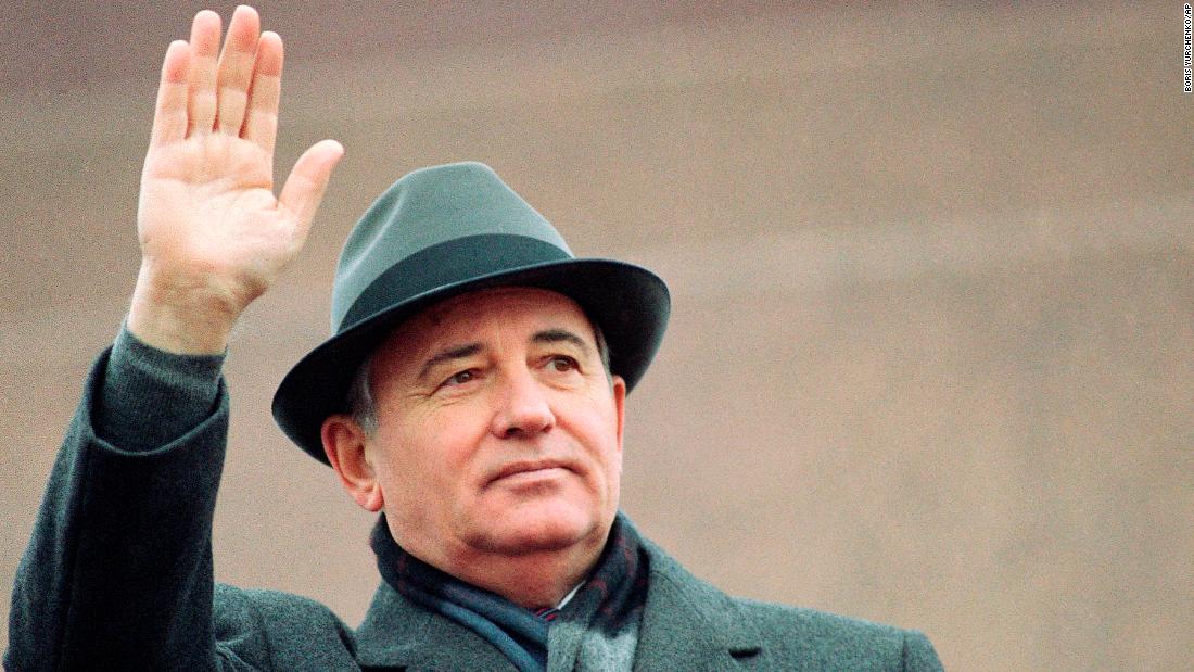 Gorbachev waves during a parade in Moscow in November 1987.