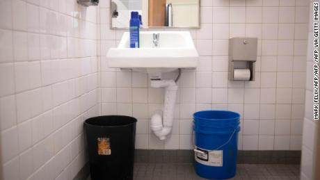 A blue bucket in a bathroom is full of water to be used for flushing the toilet at Wilkins Elementary School in Jackson, Mississippi on March 23, 2022. - Every morning, 180 students at a school in Jackson, Mississippi have to board a bus to be taken to another nearby school. The reason? Their school lacks the water pressure needed to flush its own toilets.
Cheryl Brown, the principal at Wilkins Elementary, where 98 percent of the 400 students are African-American and most come from underprivileged backgrounds, doesn&#39;t hide her frustration. (Photo by Mark Felix / AFP) (Photo by MARK FELIX/AFP /AFP via Getty Images)