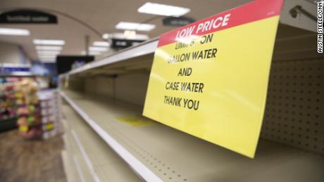 Signs restricting water purchases in Kroger, Jackson, Mississippi, Tuesday.