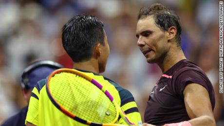 Nadal (right) and Hajikata meet at the net after their first-round match. 