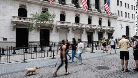 Pedestrians walking by the New York Stock Exchange on August 26. Five state-owned Chinese companies moved to delist from the exchange earlier this month. 