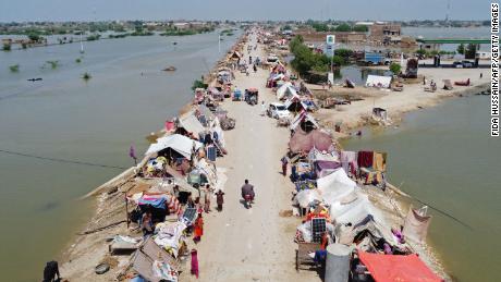 People in Pakistan take refuge from flooding in a makeshift camp on August 31 in the Jaffarabad district of Balochistan province.