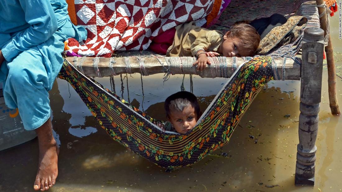 Children sit on a charpai in the Jaffarabad district on August 31.