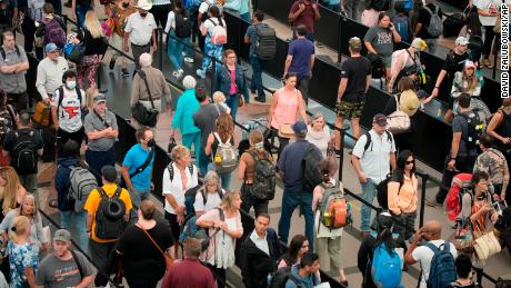 On Tuesday, August 8, travelers line up at a security checkpoint south of Denver International Airport as the Labor Day holiday approaches.  March 30, 2022.