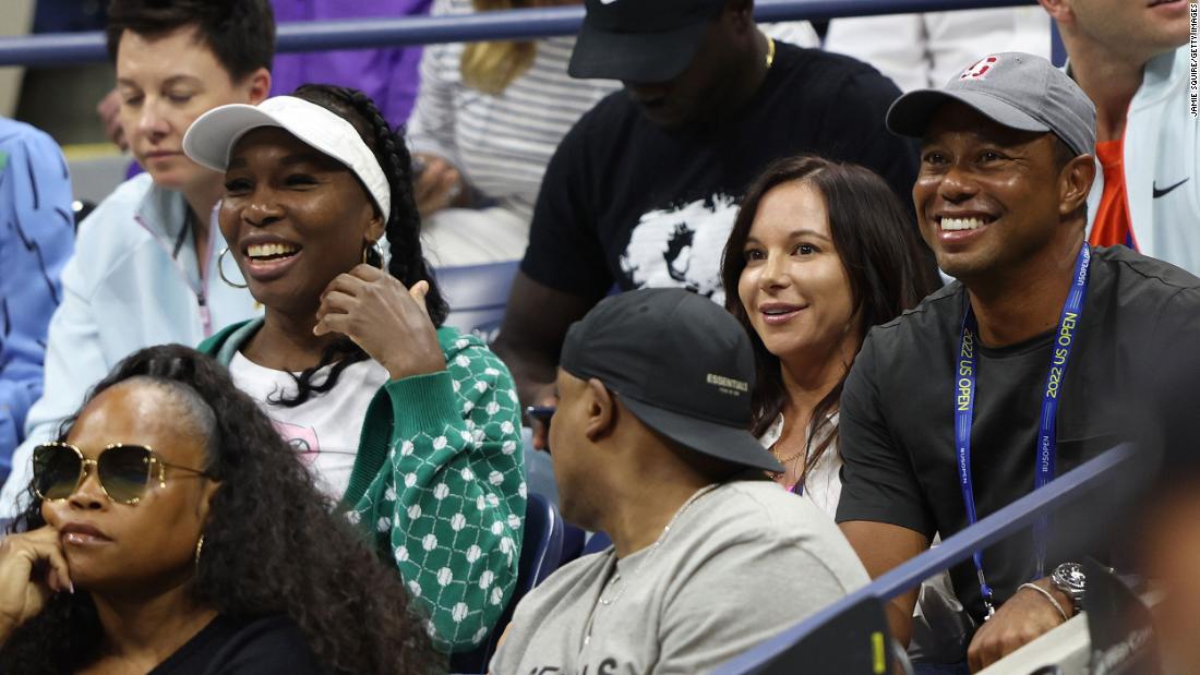 Williams&#39; sister Venus, left, watches Wednesday&#39;s match near Woods and his partner, Erica Herman.