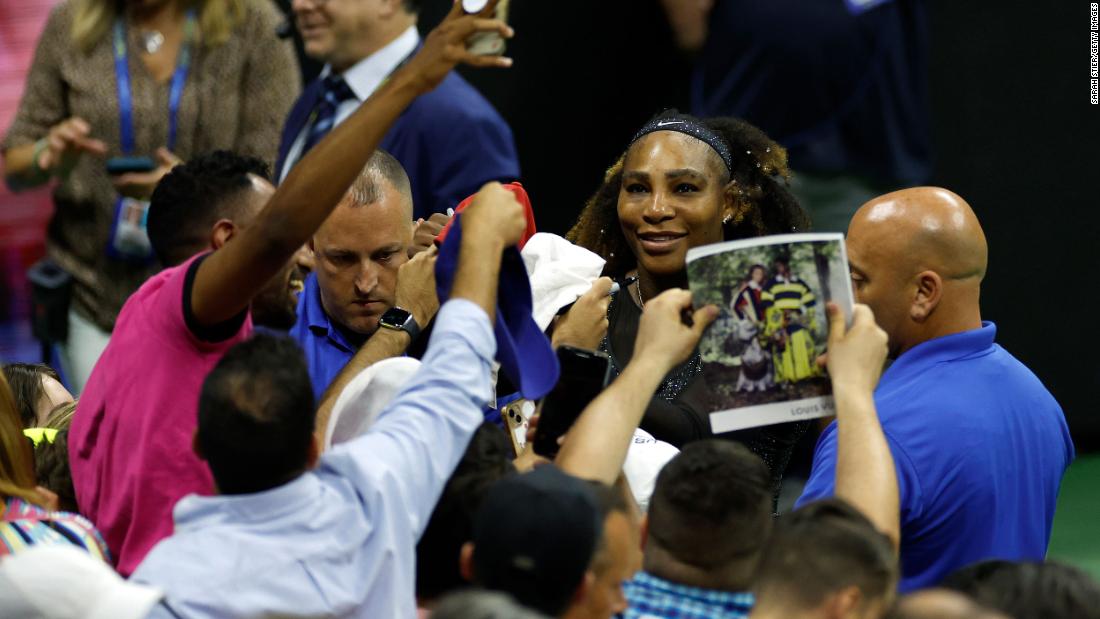 Williams takes pictures with fans at Arthur Ashe Stadium after her win on Wednesday.