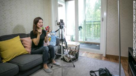 Park Su-hyang, a North Korean defector, records a YouTube video at home in Seoul, South Korea on May 19, 2018. 