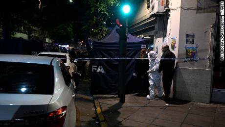 Police work behind a security cordon after a man pointed a gun at Argentine Vice President Cristina Fernandez de Kirchner outside her residence in Buenos Aires on September 1.