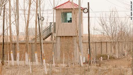 A security guard watches from a tower around a detention facility in Yarkent County in northwestern China&#39;s Xinjiang region on March 21, 2021. 