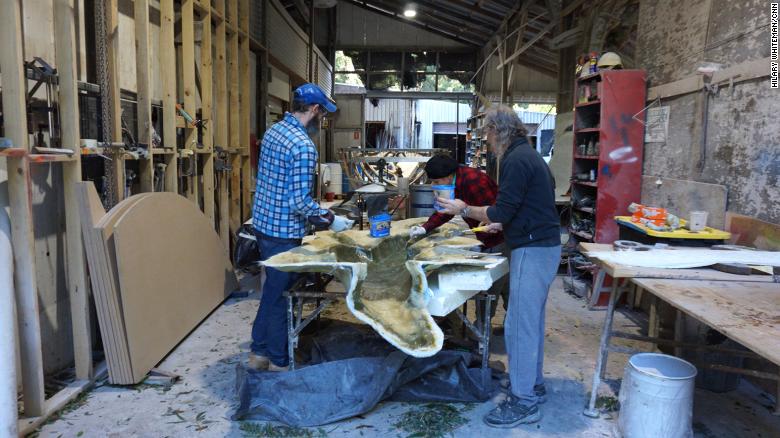 Workers at Natureworks paint a fiberglass mold of a crocodile that will be delivered to a playground.