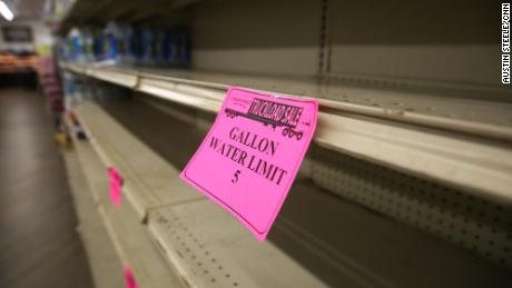 A sign limiting water purchases is seen on an empty shelf at a Corner Market in Jackson, Mississippi, on August 30.