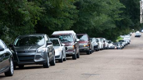 Cars line up at a water distribution site at Grove Park Community Center in Jackson, Mississippi, on August 31.