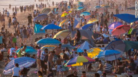 People crowd the Santa Monica Beach Saturday in California.