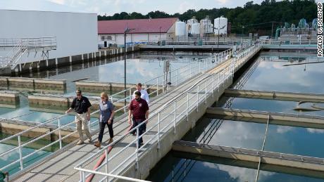 Jim Craig of the Mississippi State Department of Health, left, leads FEMA Administrator Deanne Criswell, center; Jackson Mayor Chokwe Antar Lumumba, right; and Gov. Tate Reeves, rear, as they walk past basins at the O.B. Curtis Water Treatment Facility in Ridgeland on Friday.