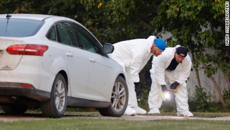 A police forensic team investigates a stabbing crime scene that left 10 dead. 