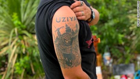 Brett Krauss shows off his tattoo in honor of his slain nephew, Ujiah Garcia, whom he was raising as his son.
