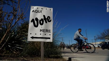 Voters leave an early voting poll site, Monday, Feb. 14, 2022, in San Antonio. Early voting in Texas began Monday.