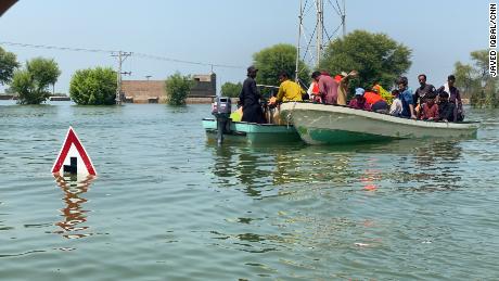 The water level is so high that residents use boats to move around the village in search of food and other supplies.