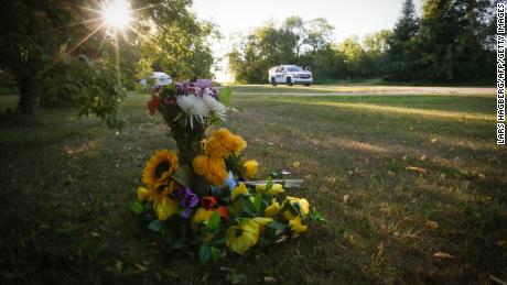 Flowers lie outside the home where one of the stabbing victims was found in Weldon, Saskatchewan.