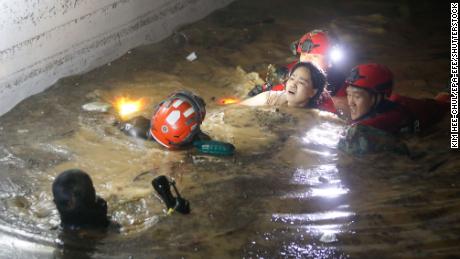 Firefighters and military officials rescue one of the missing residents from the underground parking on September 6, 2022.