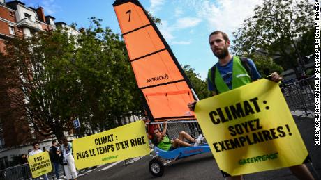 Greenpeace activists protest outside the Parc des Princes.