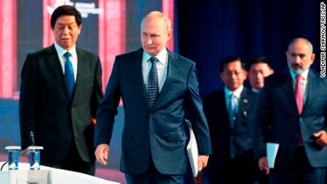 Russian President Vladimir Putin, center, Chairman of the Standing Committee of China's Congress Li Zhanshu, left, and Armenian Prime Minister Nikol Pashinyan, right, arrive for a plenary session at the Eastern Economic Forum in Vladivostok, Russia on September 7.