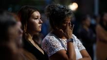 A woman cries at a memorial service for a stabbing victim in Saskatchewan, Canada.