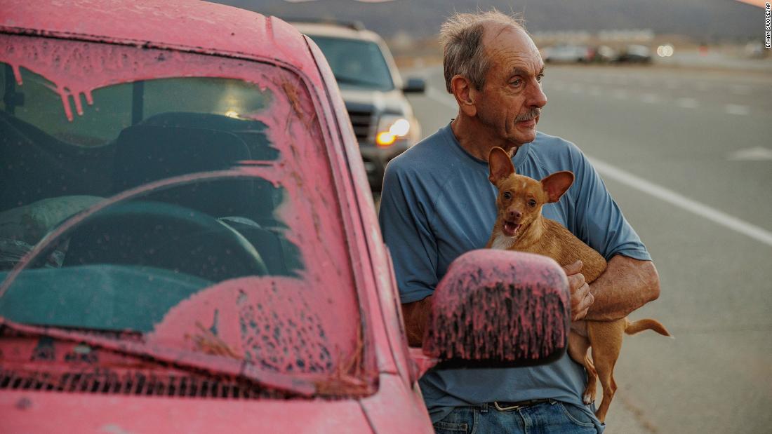 Rick Fitzpatrick holds a dog after evacuating from the Fairview Fire near Hemet on September 5. The wildfire forced residents to flee amid a severe heat wave that has enveloped the region.