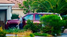 Clark County Administrator Robert Telles washes a car outside his Las Vegas home on Tuesday. Authorities on Wednesday issued a search warrant at Telles' home in connection with the fatal stabbing of Las Vegas Review-Journal investigative reporter Jeff Germann. 