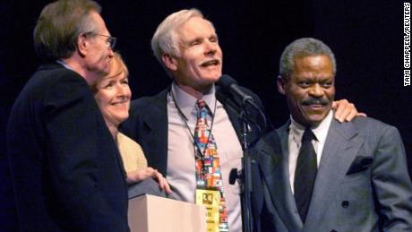 CNN founder Ted Turner (center/right) stands with anchors Larry King (L), Judy Woodruff and Bernard Shaw (R) after receiving an award at a CNN 20th anniversary gala at the Philips Arena in Atlanta on June 1, 2000.