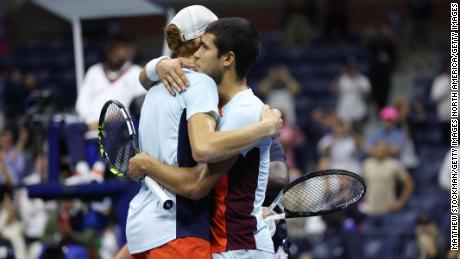 Alcaraz and Sinner embrace after their marathon quarterfinal at the US Open. 