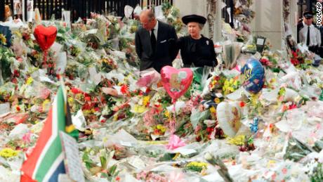Queen Elizabeth II and Prince Philip view the floral tributes to Diana, Princess of Wales, at London&#39;s Buckingham Palace, on September 5, 1997.  