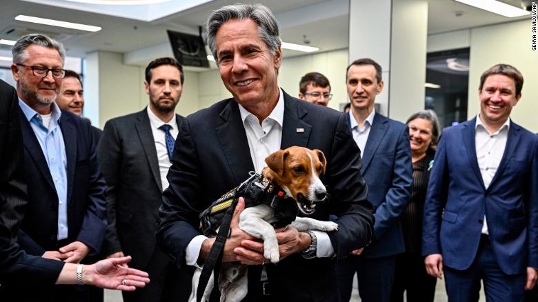 US Secretary of State Antony Blinken,holds Patron, a landmine sniffer dog, during his visit to a children&#39;s hospital in Kyiv.