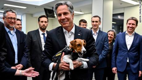 US Secretary of State Anthony Blinken holds Patron, a mine-sniffing dog, during a visit to a children's hospital in Kiev.