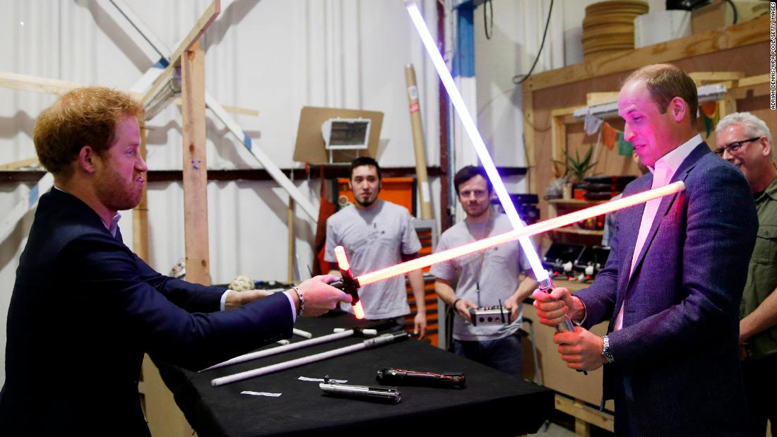 Prince William and Prince Harry try out &quot;Star Wars&quot; lightsabers during a tour of the movie sets in Iver Heath, England, in April 2016.