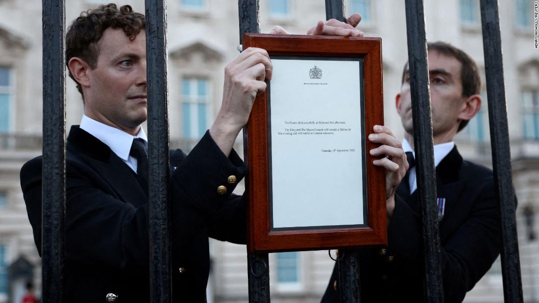 A notice is placed on a fence outside Buckingham Palace, announcing the Queen&#39;s death on September 8. &quot;The Queen died peacefully at Balmoral this afternoon,&quot; the statement read. &quot;The King and The Queen Consort will remain at Balmoral this evening and will return to London tomorrow.&quot;