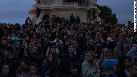 Crowds gather around the Queen Victoria memorial in front of Buckingham Palace in London after Queen Elizabeth II died on September 8.