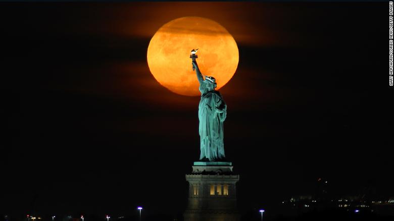 The harvest moon will glow an eerie orange color as it rises in the sky. Here’s how to watch
