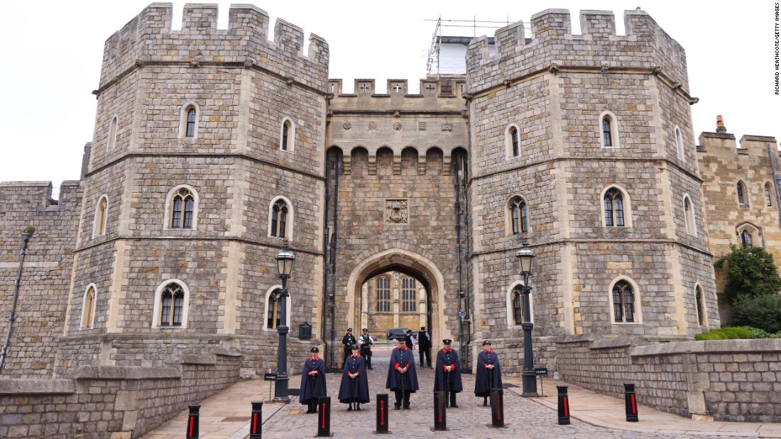 Wardens stand outside the gates to Windsor Castle on Friday.