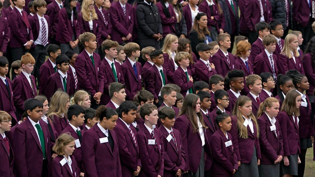 Students gather to pay their respects for the Queen at the Royal Russell School in London.