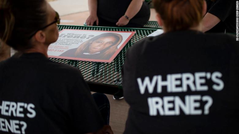 Women helping search for Irene Gakwa post signs seeking information on June 18 in Gillette, Wyoming.