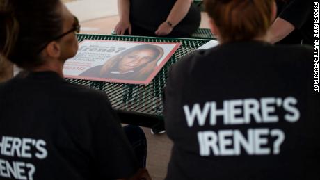 Women helping search for Irene Gakwa post signs seeking information on June 18 in Gillette, Wyoming.