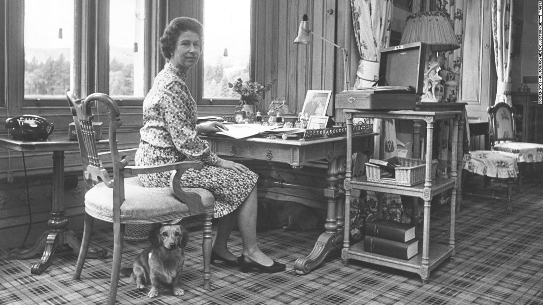 The Queen sits in her study with a corgi at her side at Balmoral Castle in 1972.
