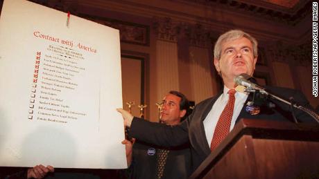 Speaker of the US House of Representatives Newt Gingrich(R-GA), holds up a copy of the  &quot;Contract With America&quot; during a rally to celebrate the first 50 days of the Republican majority in Congress in 1995.